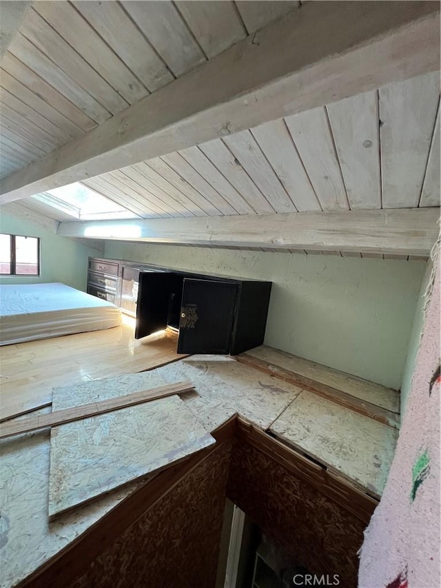 details with beamed ceiling and a skylight