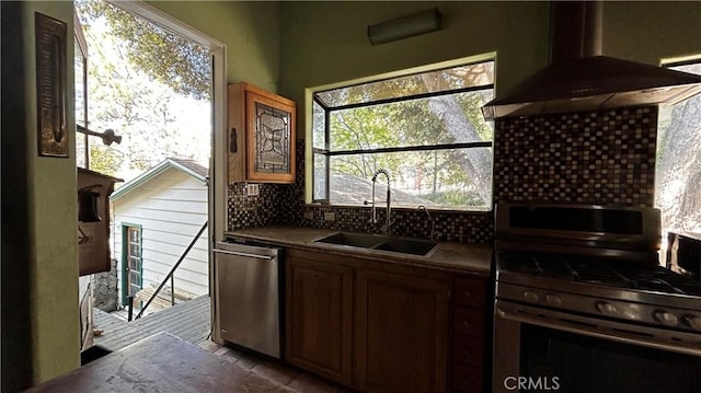 kitchen with sink, island range hood, a wealth of natural light, and appliances with stainless steel finishes