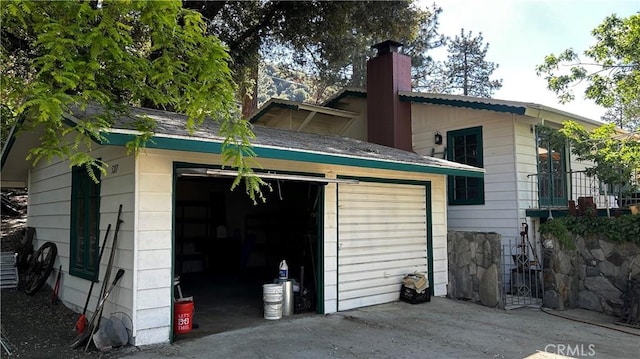 exterior space featuring a garage and an outdoor structure