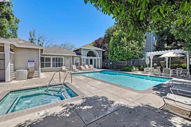 view of pool with a community hot tub, a pergola, and a patio