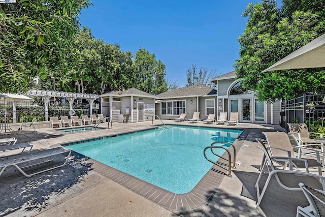 view of swimming pool with a patio and a pergola