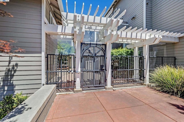 doorway to property with a pergola and a patio