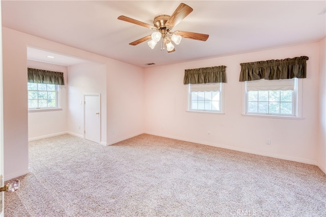 carpeted spare room with ceiling fan