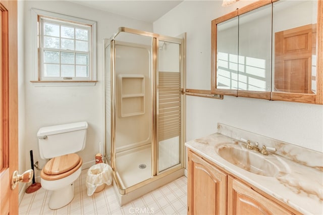 bathroom with toilet, an enclosed shower, and vanity