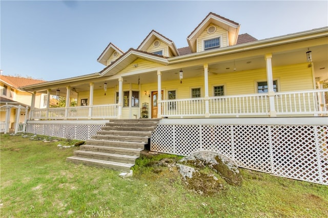 farmhouse inspired home with covered porch and a front lawn