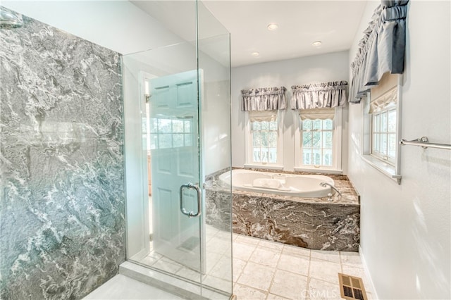 bathroom featuring separate shower and tub