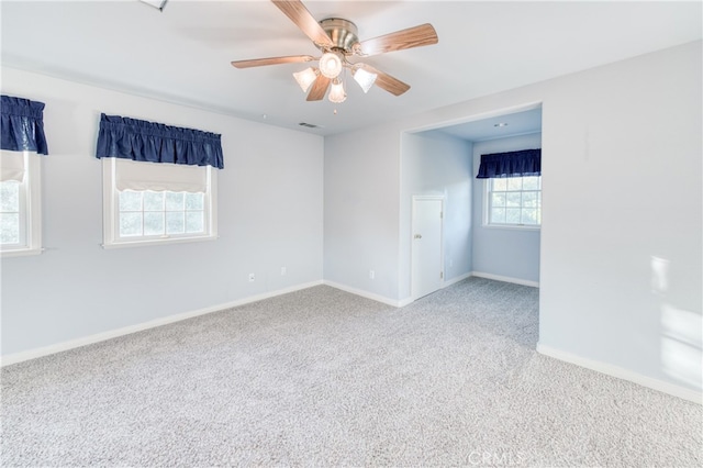 spare room featuring ceiling fan and carpet