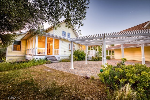 back of house with a pergola and a patio area