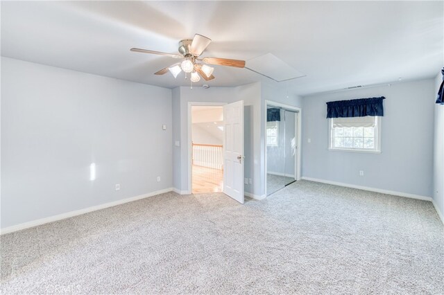 spare room with ceiling fan and light colored carpet