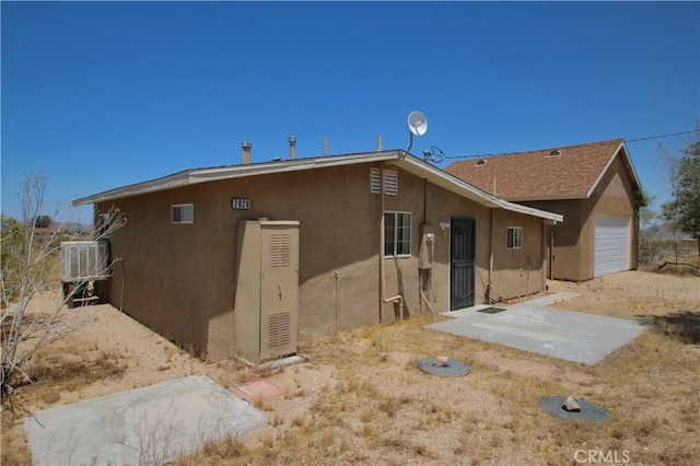 back of property with a garage