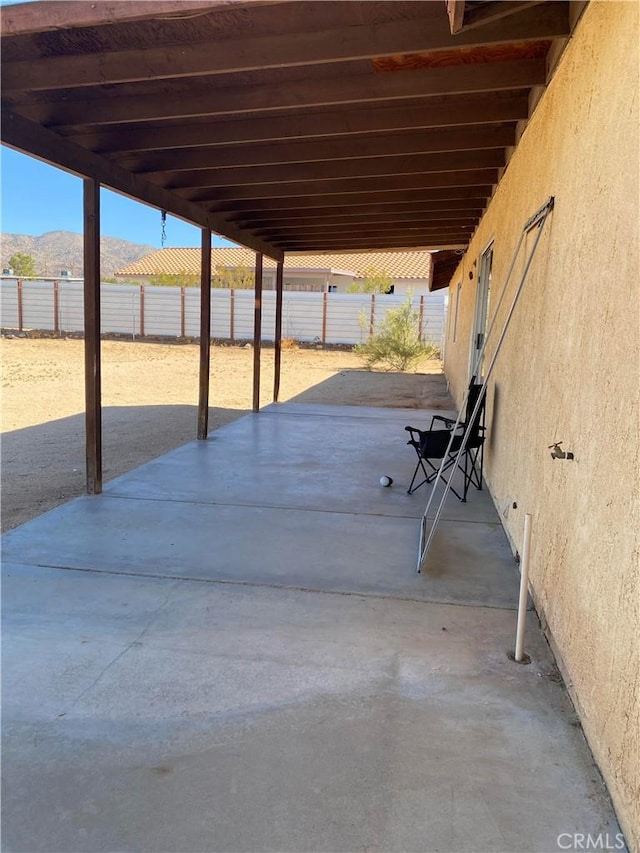 view of patio / terrace featuring fence