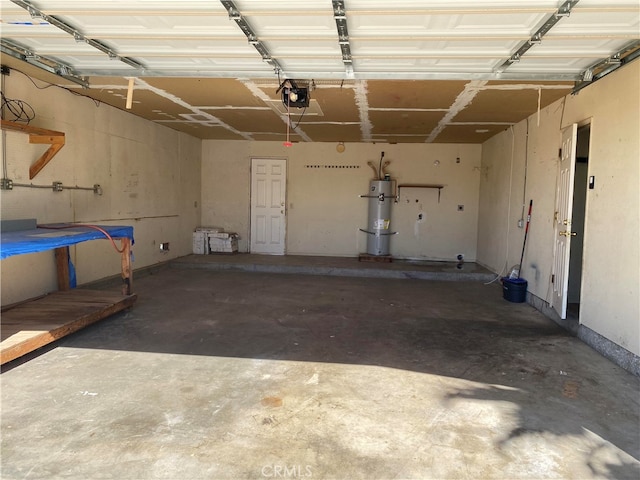 garage featuring a garage door opener and water heater