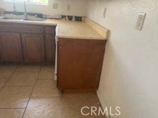 kitchen featuring sink and light tile patterned floors