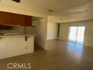 kitchen featuring a textured ceiling and tile patterned floors