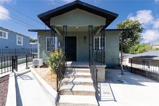 view of front of home with ac unit