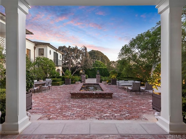 patio terrace at dusk featuring outdoor lounge area