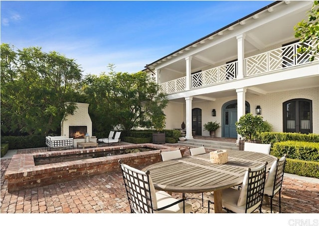 view of patio / terrace with an outdoor brick fireplace