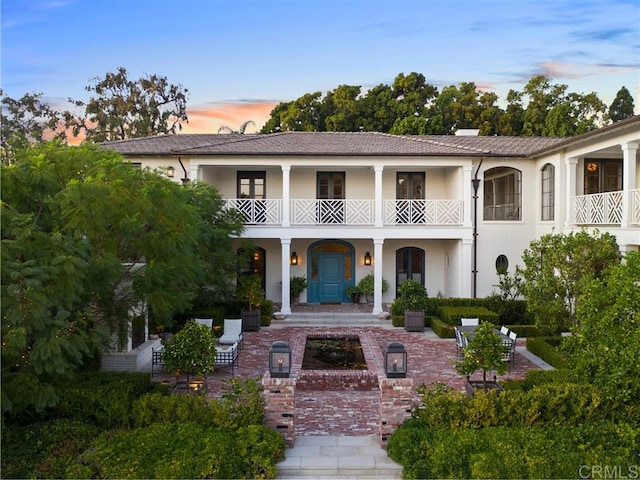 view of front of home with a patio and a balcony