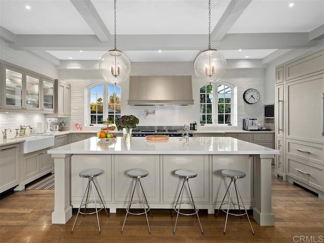 kitchen with a kitchen breakfast bar, beam ceiling, and a spacious island