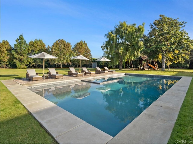 view of swimming pool featuring a patio area, a yard, and a playground