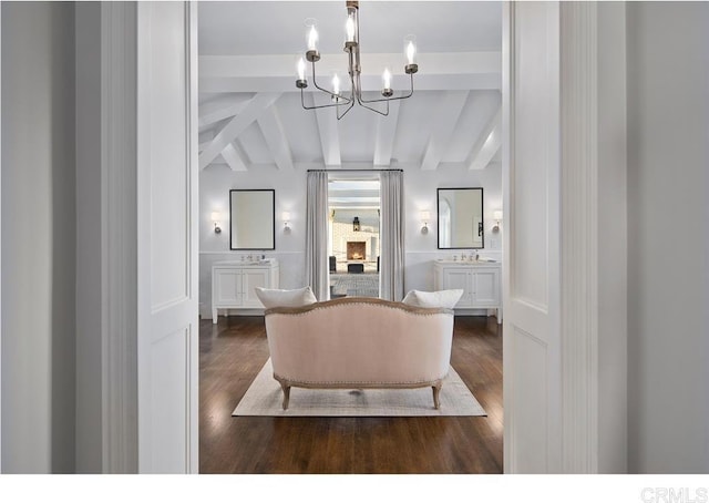 living room featuring sink, vaulted ceiling with beams, an inviting chandelier, and dark hardwood / wood-style floors