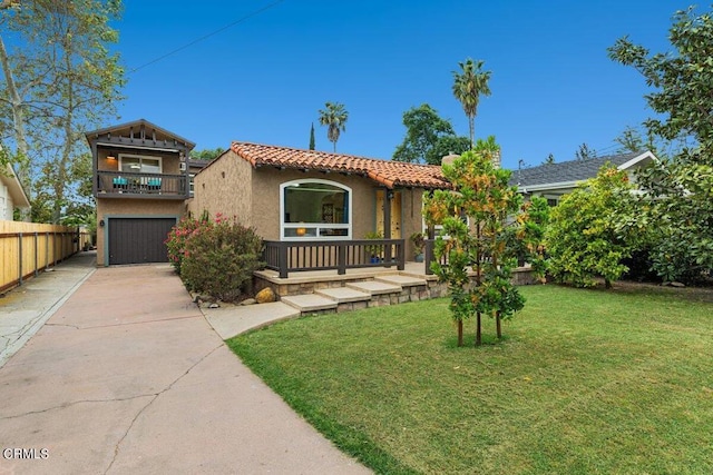 mediterranean / spanish-style home featuring a garage, a front lawn, and a balcony