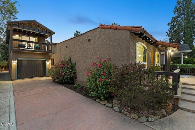 view of front of house featuring a balcony and a garage