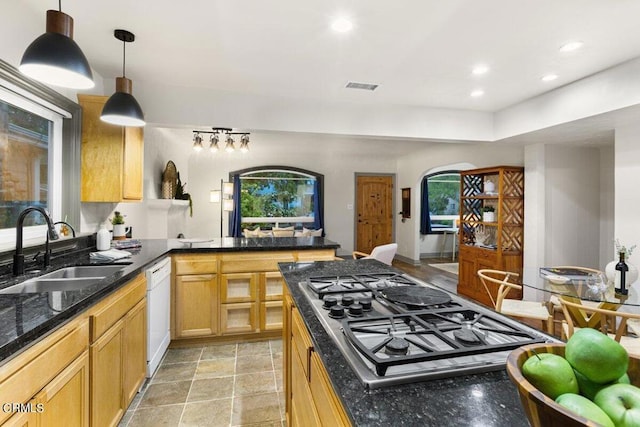 kitchen with sink, decorative light fixtures, light brown cabinets, dishwasher, and stainless steel gas stovetop