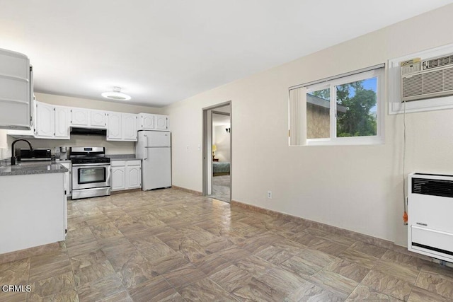 kitchen with sink, white cabinetry, white refrigerator, heating unit, and stainless steel range