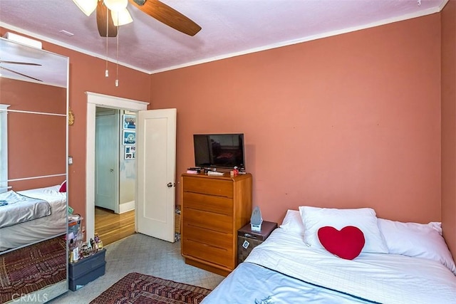 bedroom featuring ceiling fan and crown molding