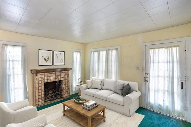 carpeted living room with a fireplace and a wealth of natural light