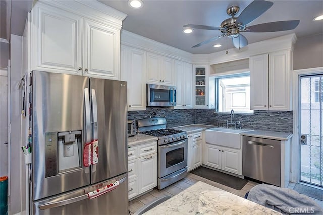 kitchen with sink, stainless steel appliances, and white cabinetry