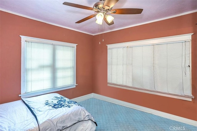 bedroom with ceiling fan, multiple windows, carpet, and ornamental molding