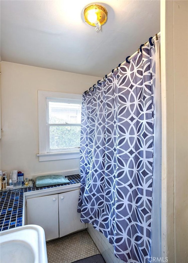 bathroom with tile patterned floors