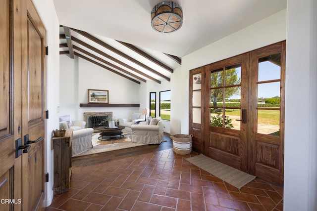 tiled foyer entrance with vaulted ceiling with beams