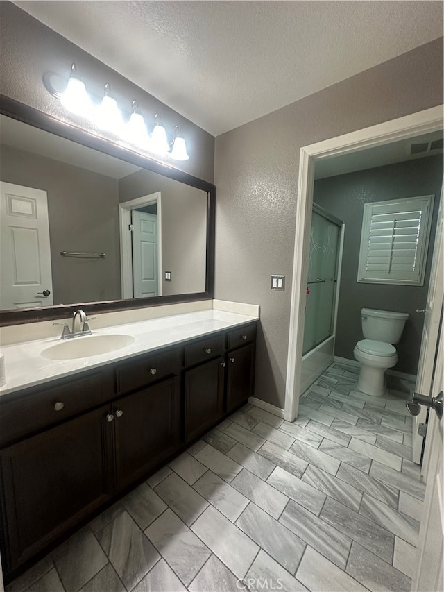 bathroom featuring tile patterned flooring, toilet, and vanity