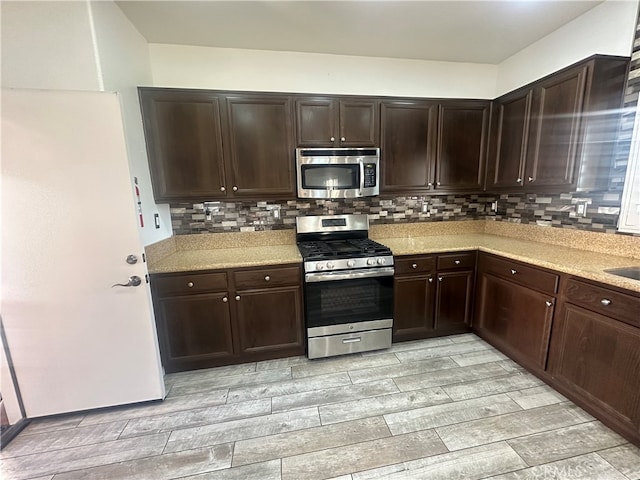 kitchen with tasteful backsplash, stainless steel appliances, and dark brown cabinets