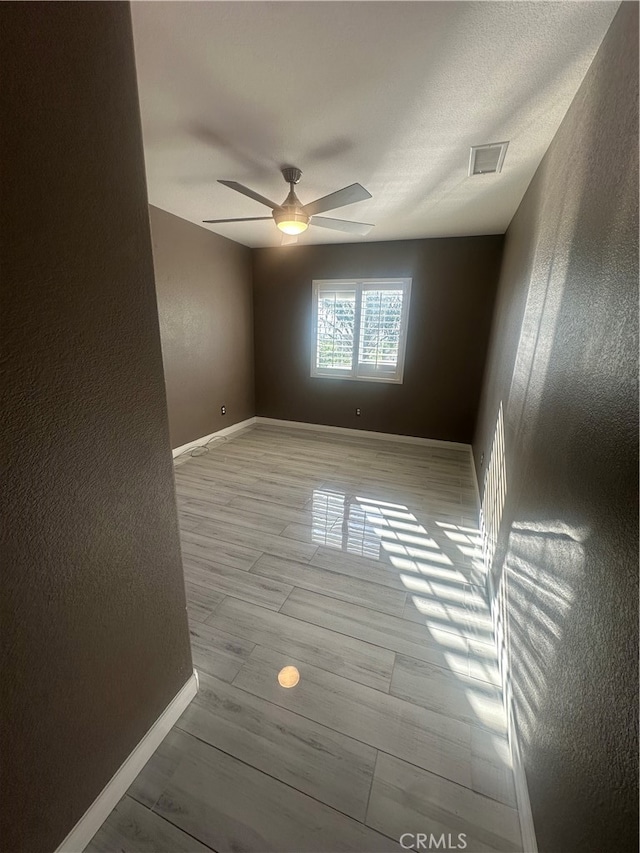 unfurnished room featuring ceiling fan and light hardwood / wood-style floors