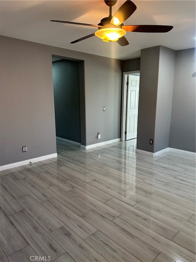 unfurnished room with ceiling fan