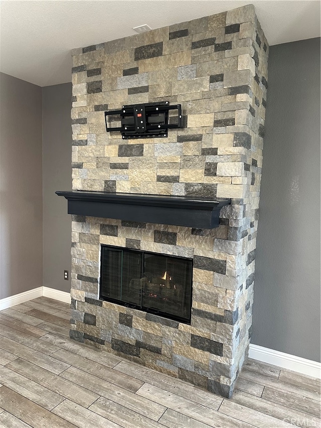 interior details with hardwood / wood-style flooring and a fireplace