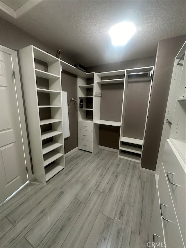 spacious closet featuring light wood-type flooring