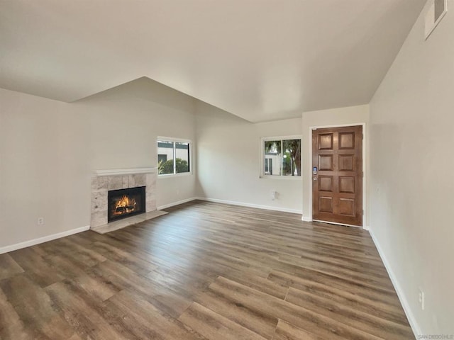 unfurnished living room featuring a fireplace and dark hardwood / wood-style floors