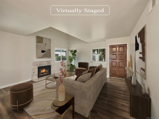 living room with a tile fireplace and wood-type flooring