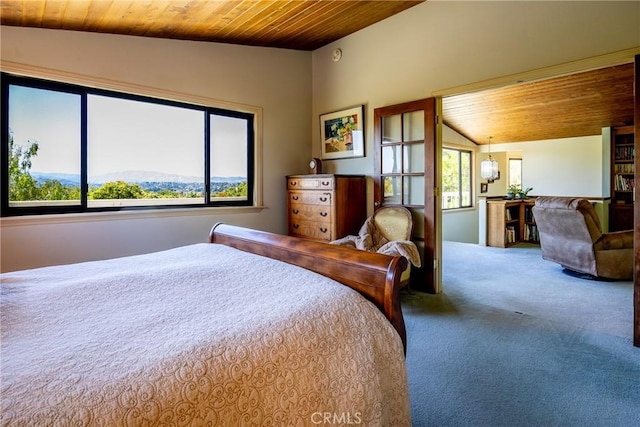 carpeted bedroom featuring a mountain view, wooden ceiling, and vaulted ceiling