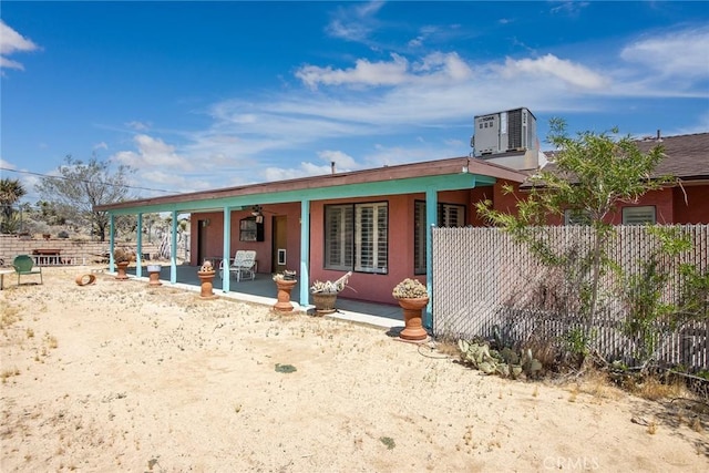 view of front of property with ceiling fan, a patio area, and central air condition unit