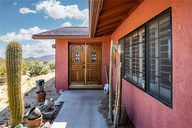 view of exterior entry featuring a mountain view