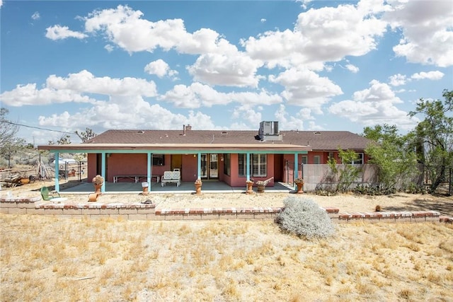 view of front of house with a patio and central AC unit