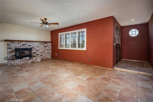 unfurnished living room with a textured ceiling, a wood stove, and a wealth of natural light