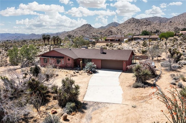 ranch-style house featuring a mountain view and a garage