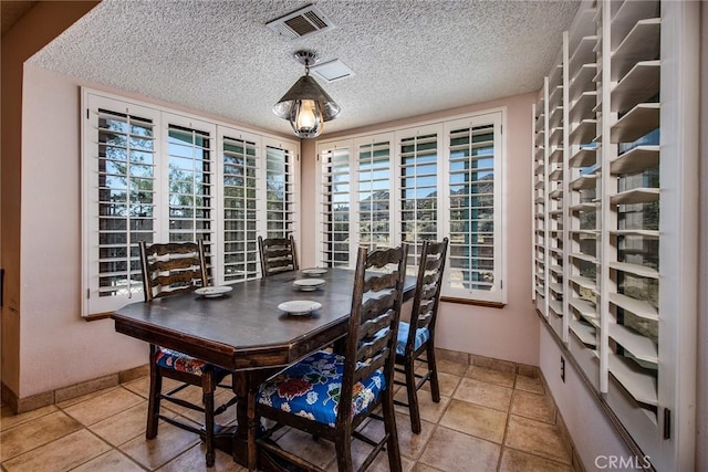 wine cellar featuring tile patterned flooring and a textured ceiling